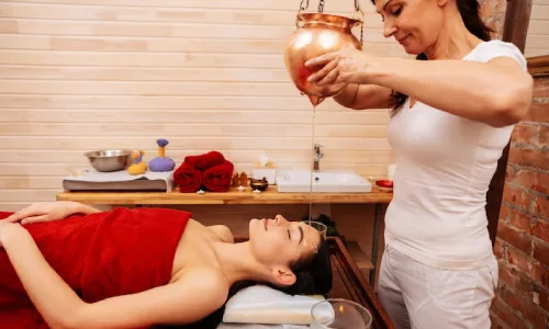 Therapy using warm herbal oils poured over the body to relieve headaches, muscle spasms, joint pain, and depression, promoting deep relaxation and full-body healing, especially for stress-related conditions.